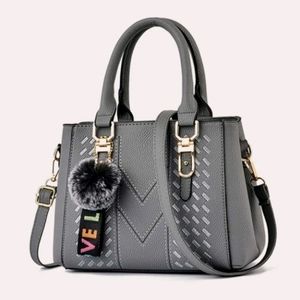 Pom-pom double handle hand bag